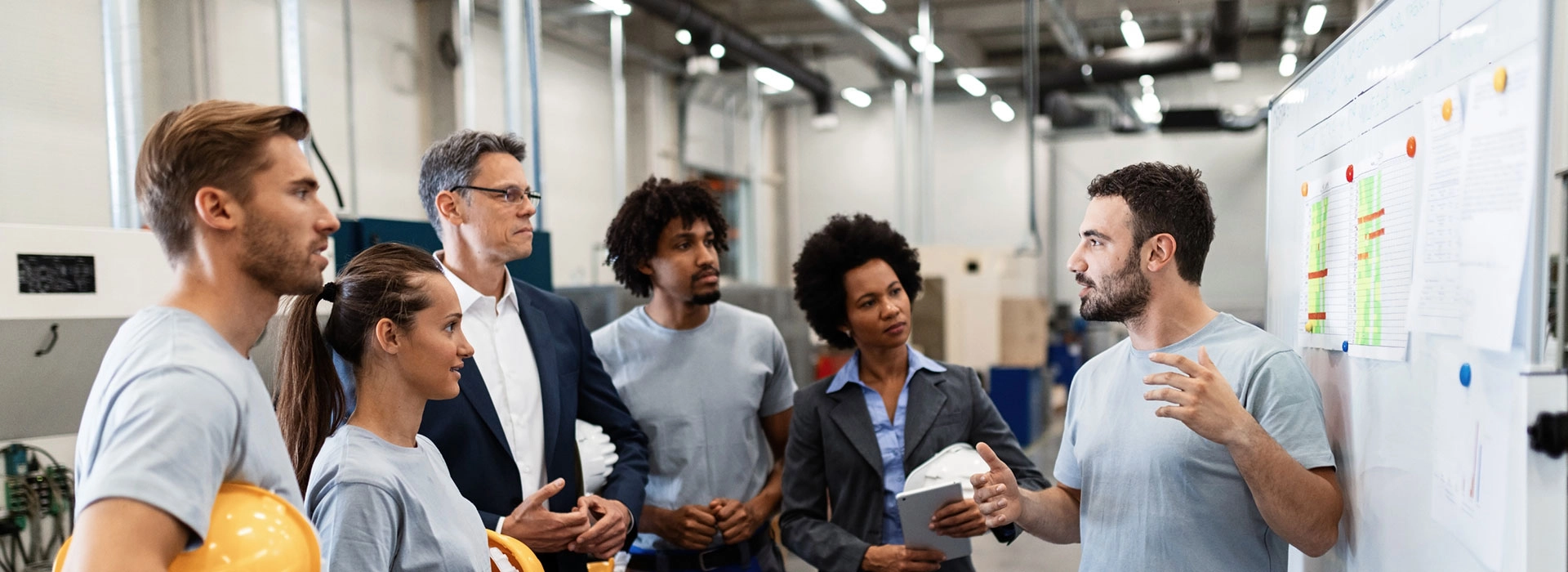 A man talking to a group of individuals.